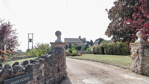 A stone wall with a sign reading "HAM HOUSE" leading to a building with a traditional design. - The Forge (Taunton)