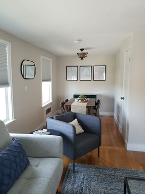 Relax in a comfortable seating area with a sofa and armchair, perfect for unwinding or socializing.