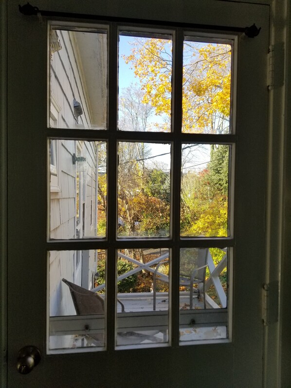Enjoy a serene view of the surrounding area from this cozy room's six-pane window.