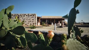 A building with a stone facade and a thatched roof structure.