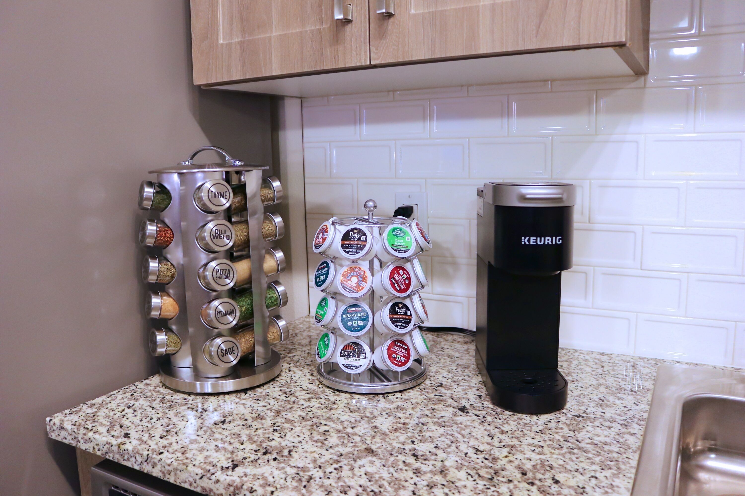A kitchen counter with a coffee maker and two spice containers.