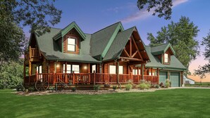 A log cabin with a wrap-around porch, large windows, and a green roof. - Heated Seasonal Pool, Hot Tub & Theater • Rustic Cabin by Bike Path (Celina)