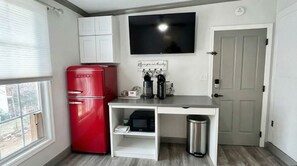 Fridge, microwave, coffee/tea maker, cookware/dishes/utensils