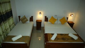 Two double beds with wooden headboards and nightstands, each with a wall-mounted light. - Dream Weaver Eco Homestay Sigiriya (Sigiriya)