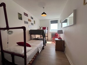 A dormitory room with bunk beds, a desk, a chair, a lamp, and a window with a view. - Fantastic View over London apartment in Abbey Road (London)