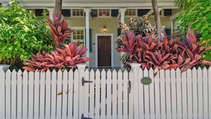 A white picket fence with a mailbox and a house number 314.
