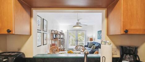 A kitchen with wooden cabinets, a stainless steel sink, a toaster, and a coffee maker.