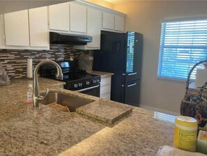 Enjoy cooking in this well-equipped kitchen with a stove, oven, and refrigerator.