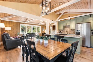 A spacious kitchen with wooden cabinets, a large island, and stainless steel appliances.