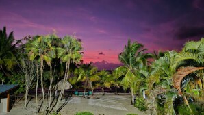 A beach with palm trees and a hut. - 2BR Beachfront Bungalow-Pool & Oceanfront-Views (Placencia)