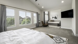 A bedroom with a large bed, a ceiling fan, and a TV mounted on the wall. - Clean, modern, golf course home w/ incredible mtn views, close to hike/golf/ski. (Pleasant Grove)