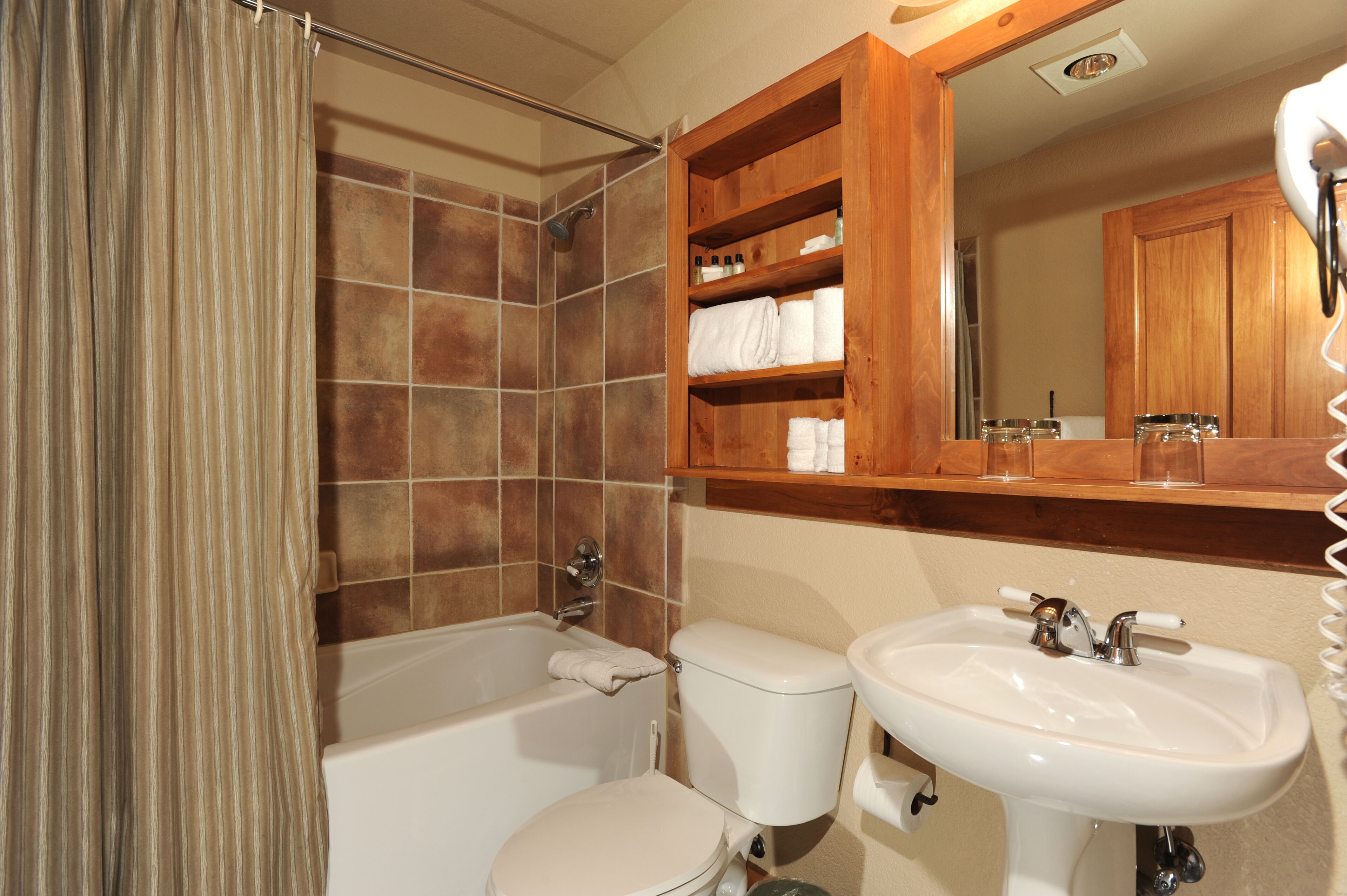 A bathroom with a bathtub, toilet, and sink.