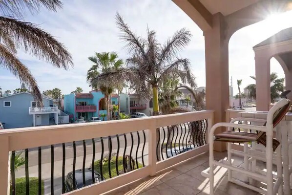 Enjoy the view from this balcony with a pair of comfortable chairs.