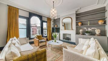 Basic Apartment, Multiple Beds | Living area | TV