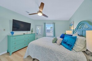 A bedroom with a bed, a ceiling fan, a television, a dresser, and a window with blinds. - 🏝Stunning Retreat-Private Beach-Umbrella Service for 4 - Dog Friendly (Miramar Beach)