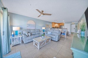 A living room with two grey sofas, a coffee table, and a ceiling fan. - 🏝Stunning Retreat-Private Beach-Umbrella Service for 4 - Dog Friendly (Miramar Beach)
