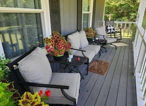 Relax in a serene outdoor space with a comfortable seating area featuring a round table and three chairs.