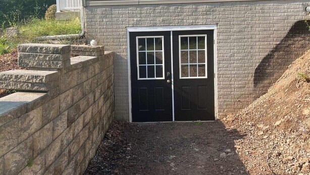 A two-story house with a brick foundation and a covered porch. - Cozy 2 bedroom suite with private entrance and continental breakfast. (Port Matilda)