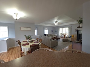 A spacious living area with a dining table, sofas, and a television. - Lakefront, private dock on cove near HaHa Tonka, Ballparks National Park, kayaks (Camdenton)