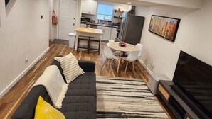 Een modern appartement met een woonkamer, eethoek en keuken.