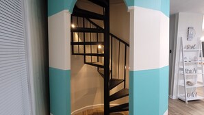 A staircase with a teal and white color scheme, leading to an upper floor.