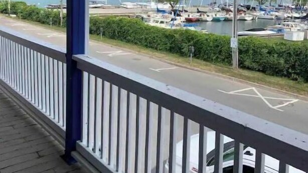 A balcony with a view of a marina and boats. - Historical King George Inn 1 (Niagara-on-the-Lake)