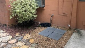 A brick exterior with a window, a door, and a hose on the ground. - Canal front pool home to Dora Chain of Lakes (Tavares)