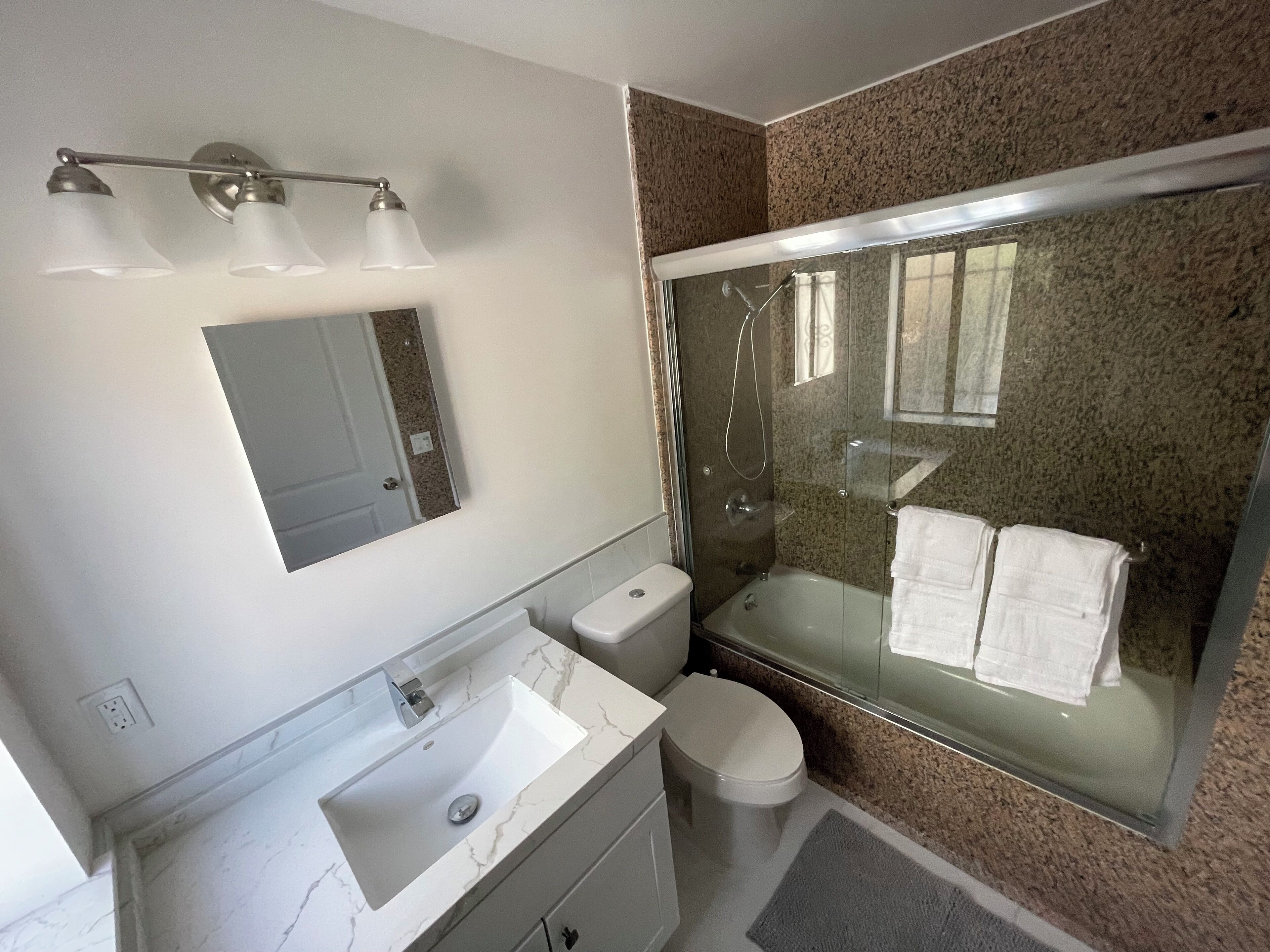 Combined shower/tub, towels, toilet paper