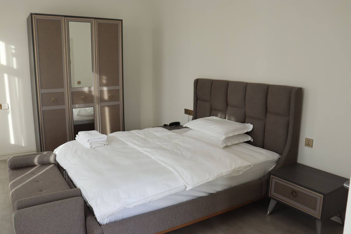 Premium bedding, memory foam beds, desk, laptop workspace