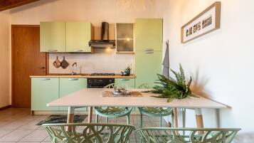 Apartment, 2 Bedrooms, Smoking, Balcony | Private kitchen | Coffee/tea maker, microwave, stovetop, dining tables