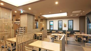 A modern restaurant with wooden furniture and a high ceiling.
