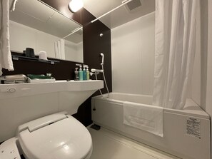 A modern bathroom with a toilet, sink, and shower.