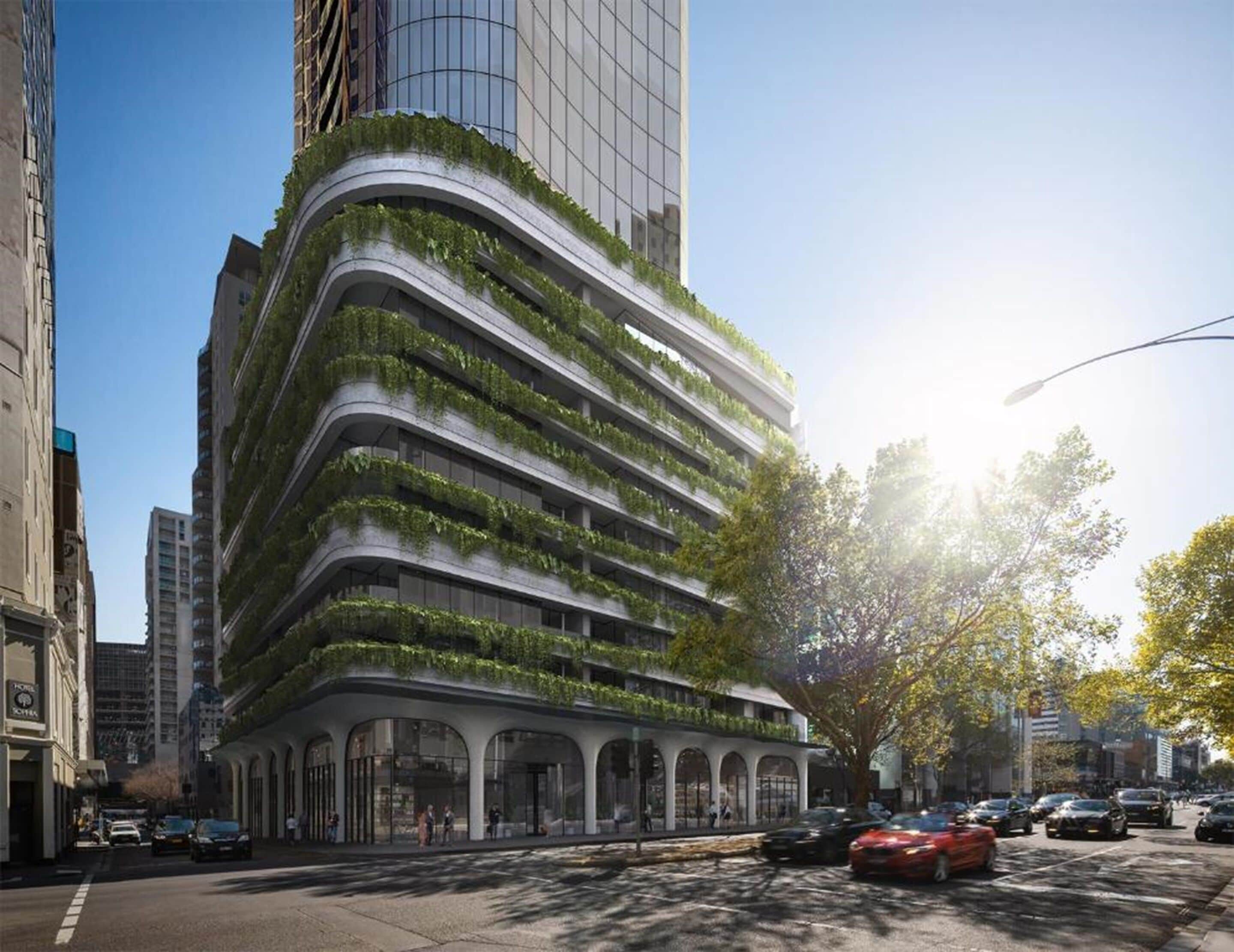 A modern building with curved architecture and green terraces.