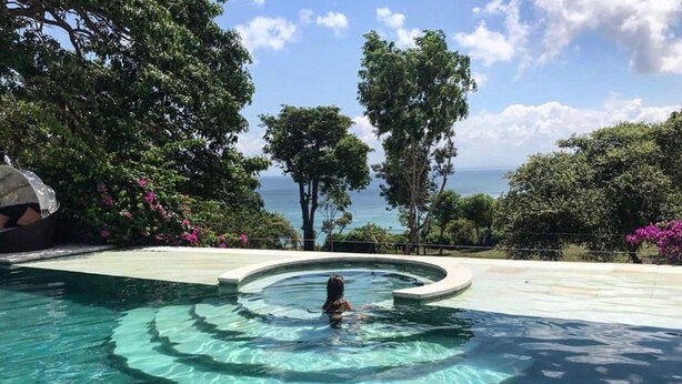 A pool with clear water, surrounded by trees and a view of the ocean. - The Backyard Bingin - Cliff Top 10 bedroom Private Villa by Bingin Beach (Pecatu,)