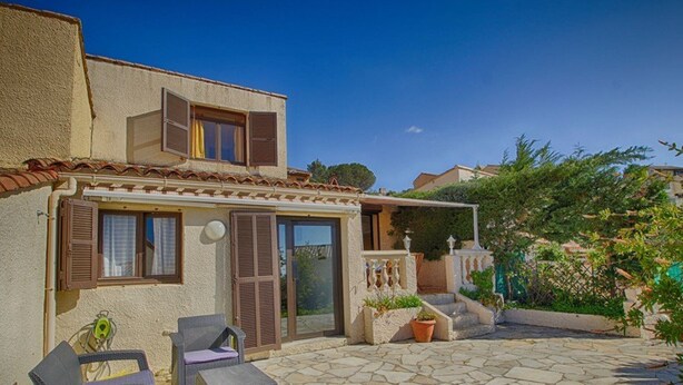 A two-story building with a stone patio, outdoor seating, and a small garden area. - Charming Villa w/ Pool, Tennis, A/C, Near Beach in Porticcio - Sleeps 6 (Porticcio)