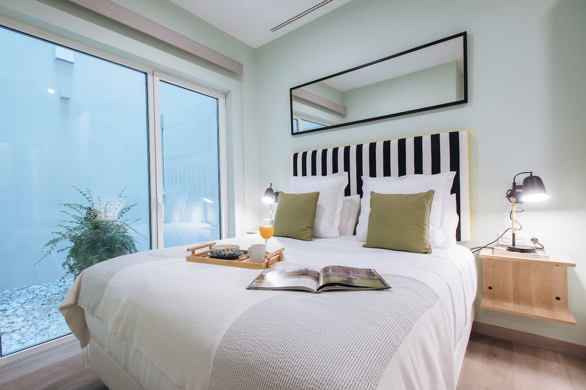 Desk, laptop workspace, bed sheets