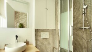 A modern bathroom with a large white sink, a glass shower enclosure, and a tiled backsplash. - Charon 2 - Studio Apartment, Sleeps 2 (Paris)