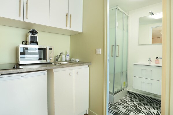 A modern kitchen with a microwave, sink, and cabinets.