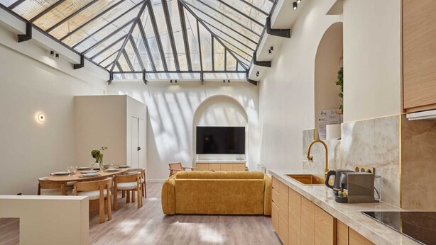 A modern kitchen with a skylight, wooden cabinets, and a built-in oven. - Meslay 3 - Two Bedroom Apartment, Sleeps 6 (Paris)