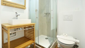 A modern bathroom with a glass-enclosed shower, a white sink, and a toilet. - Meslay 9 - One Bedroom Apartment, Sleeps 4 (Paris)