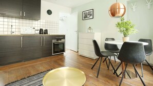 A modern kitchen with dark wood cabinets, a stainless steel oven, and a white tiled backsplash. - Meslay 9 - One Bedroom Apartment, Sleeps 4 (Paris)