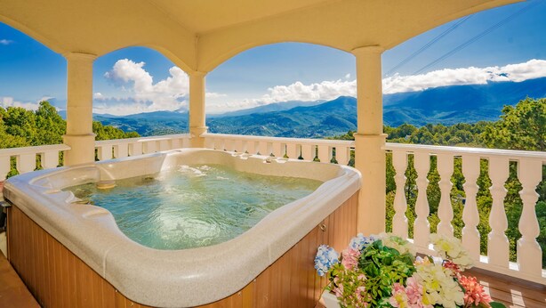 A hot tub on a balcony with a mountain view.