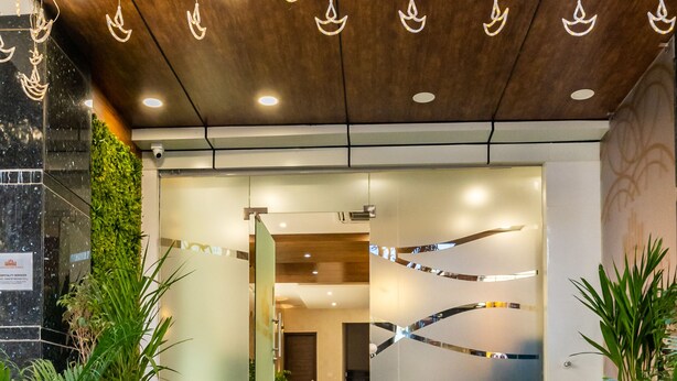 A modern hotel entrance with a staircase leading to a reception area. - Bangalore Times by Alaya Stays (Bengaluru)
