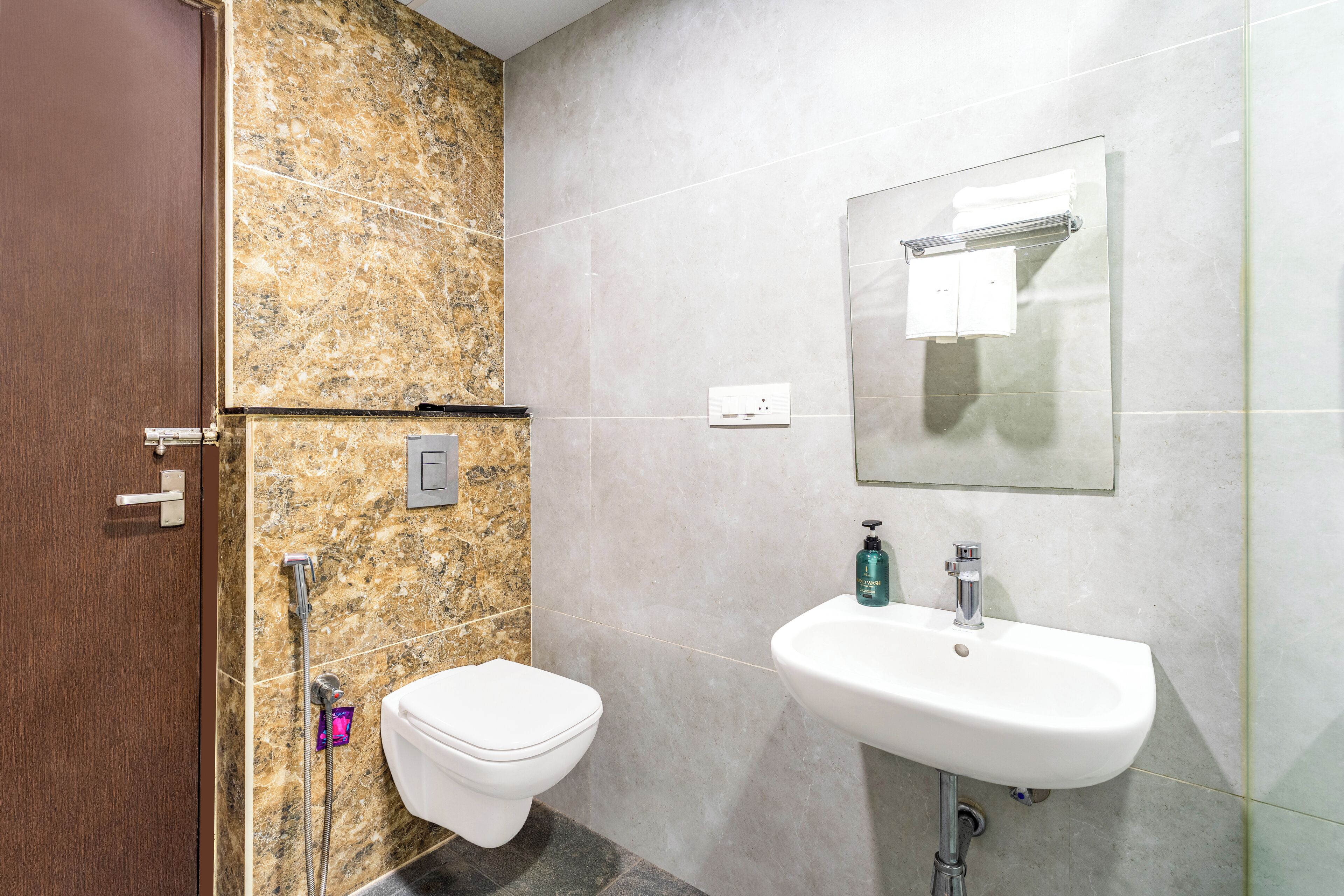 A bathroom with a toilet, sink, and shower.