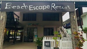 The exterior of Beach Escape Resort with a sign indicating no parking.