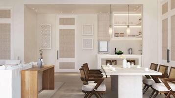 A modern kitchen with a central island, wooden chairs, and a dining table.