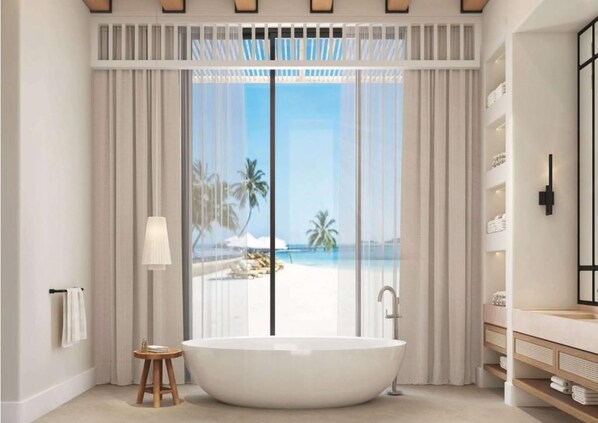 A modern bathroom with a freestanding bathtub, a large window with a view of a beach, and a minimalist vanity with shelves. - Maysan Doha Lxr Hotels & Resorts (Al Rayyan)