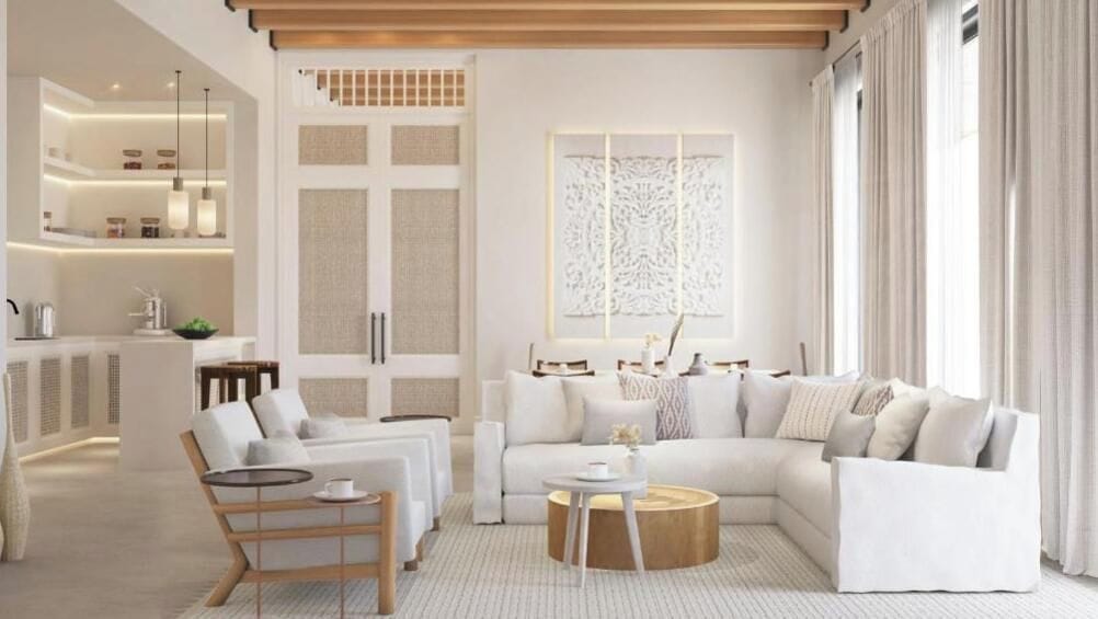 A modern living room with a sofa, coffee table, and a dining area with a table and chairs.