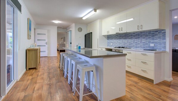 Enjoy cooking in this well-equipped kitchen with a central island and bar stools.
