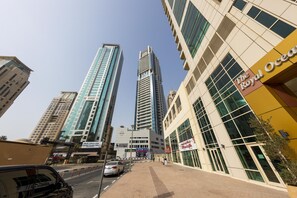 A cityscape with modern high-rise buildings, including a prominent hotel named "The Royal Ocean."